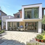 Modern rear house extension with sliding glazing onto a London garden patio